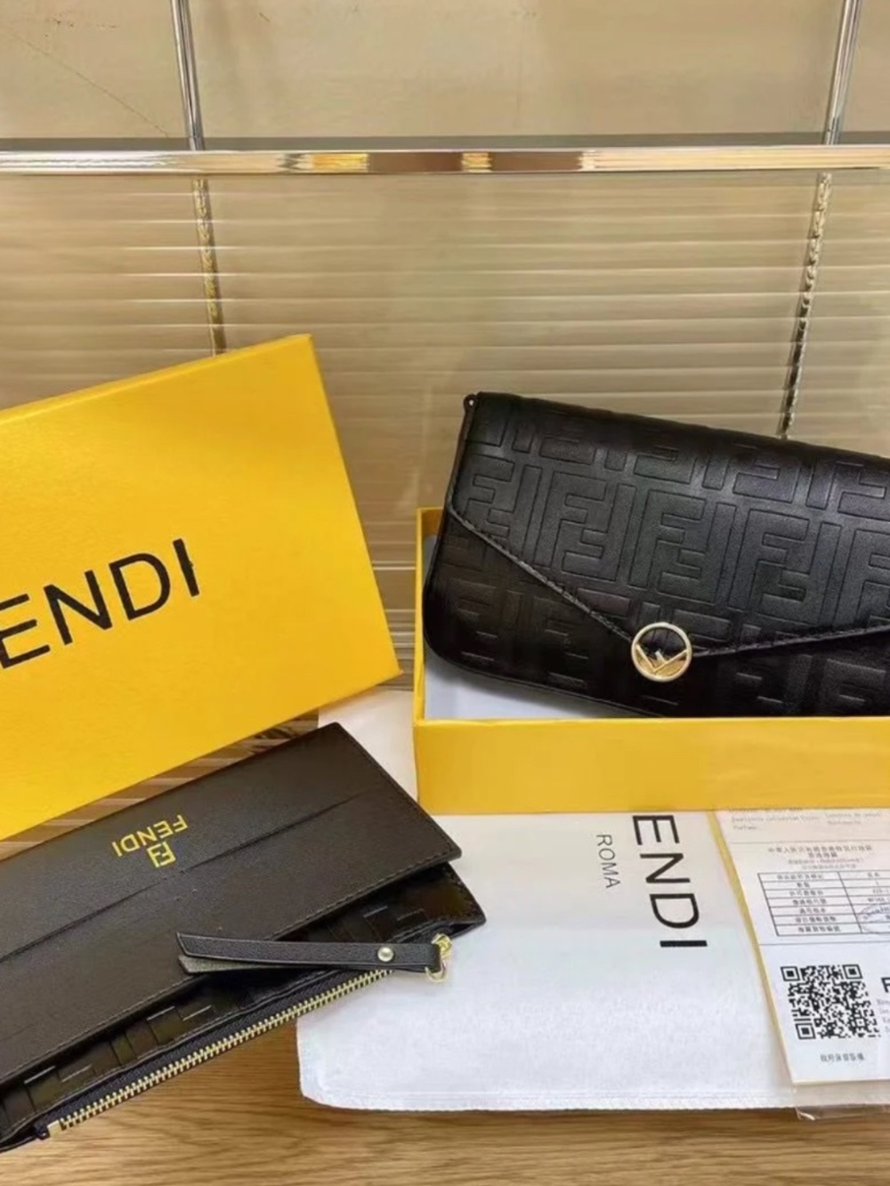 Fendi black handbag with a hanging strap/chain.